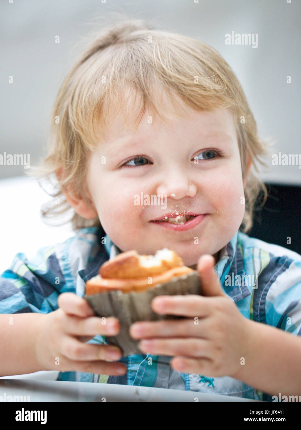 Little boy eating muffin Stock Photo Alamy