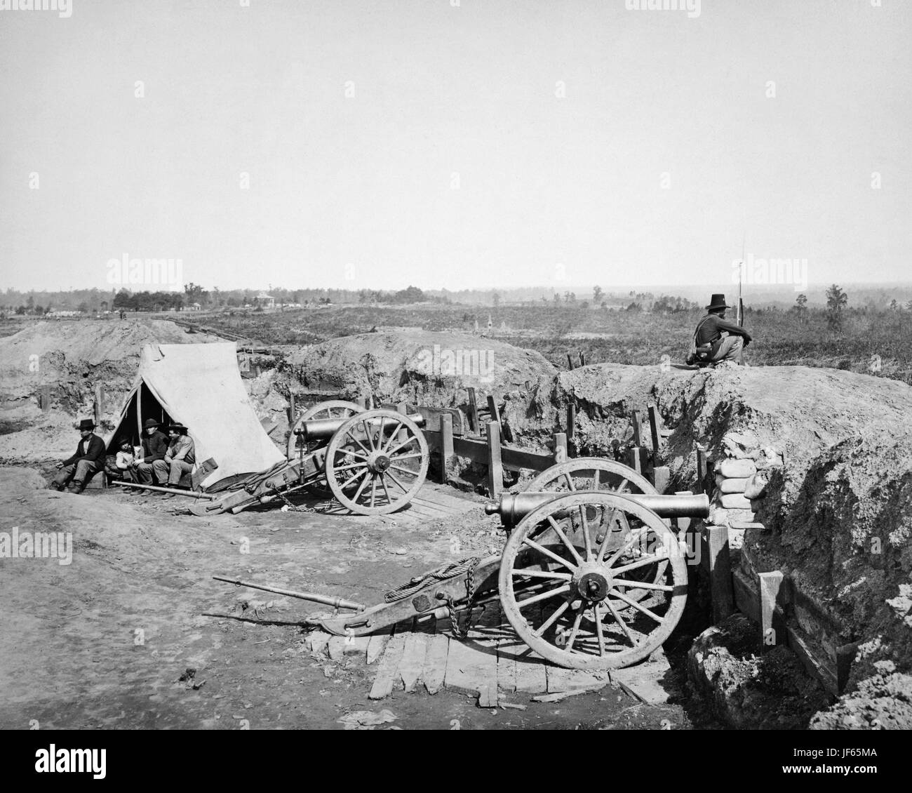 View from Confederate fort, east of Peachtree Street, looking east, Atlanta, Georgia. Fortifications with cannons, confederate lookout and soldiers in tent. CREATED/PUBLISHED:  [1864, printed later]  SUMMARY:  Fortifications with cannons, confederate lookout and soldiers in tent.  MEDIUM:  1 photographic print.  CREATED/PUBLISHED:  [1864, printed later]  CREATOR:  Barnard, George N., 1819-1902, photographer. Stock Photo
