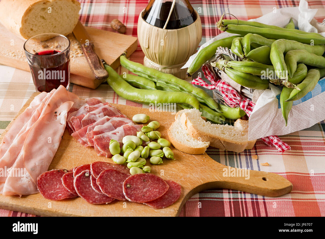 Chopping board of cold meats and broad bean Stock Photo