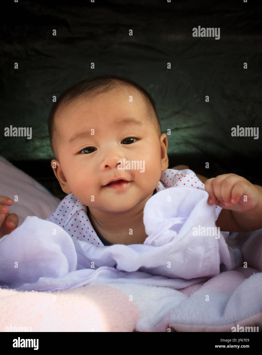 aisan baby lying on bed good emotion and healthy Stock Photo Alamy