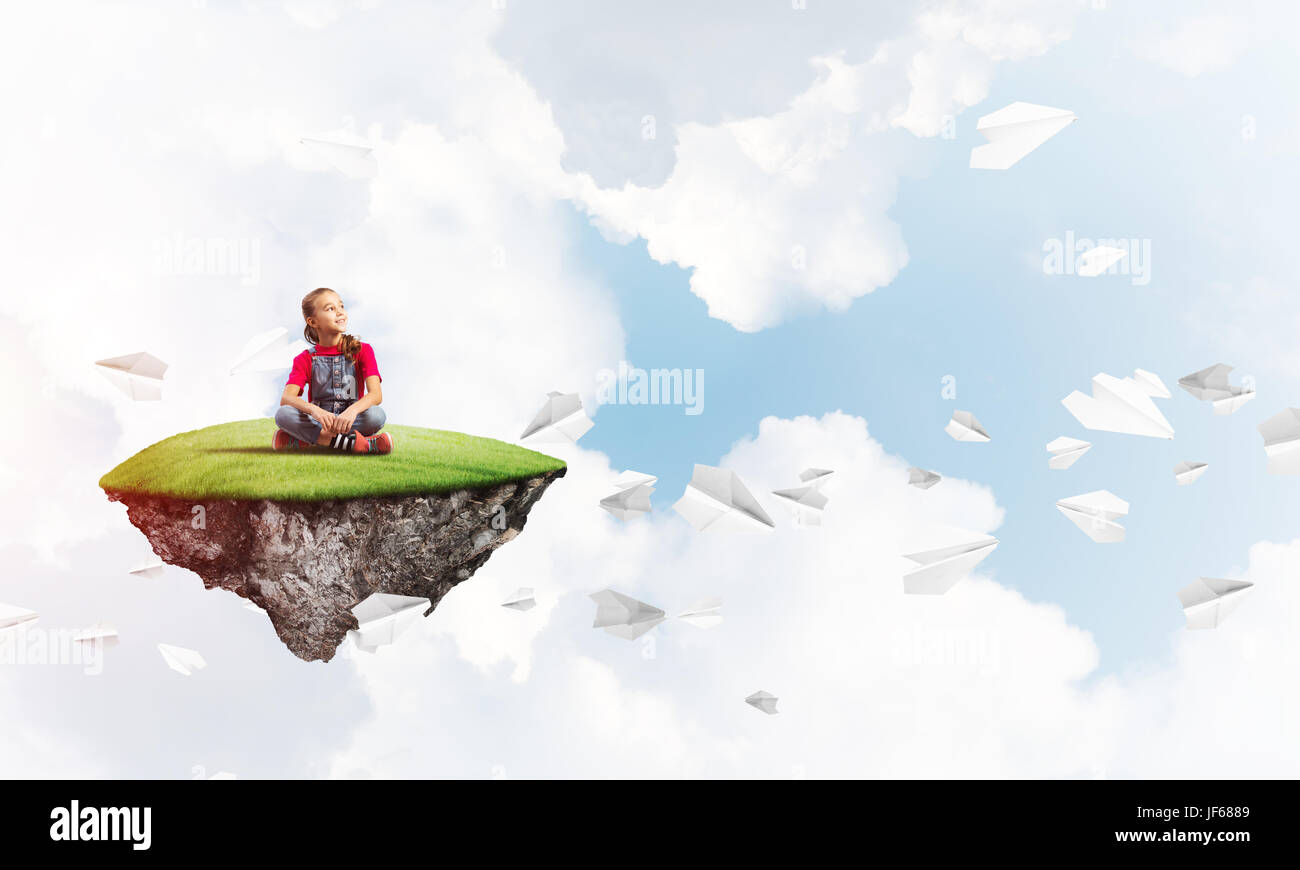 Cute smiling girl on floating island and paper planes flying around ...