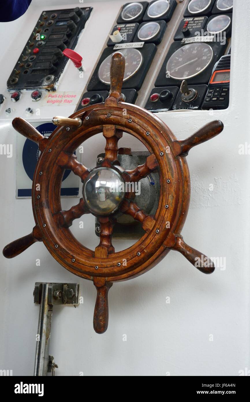 Steering wheel on small boat Stock Photo Alamy