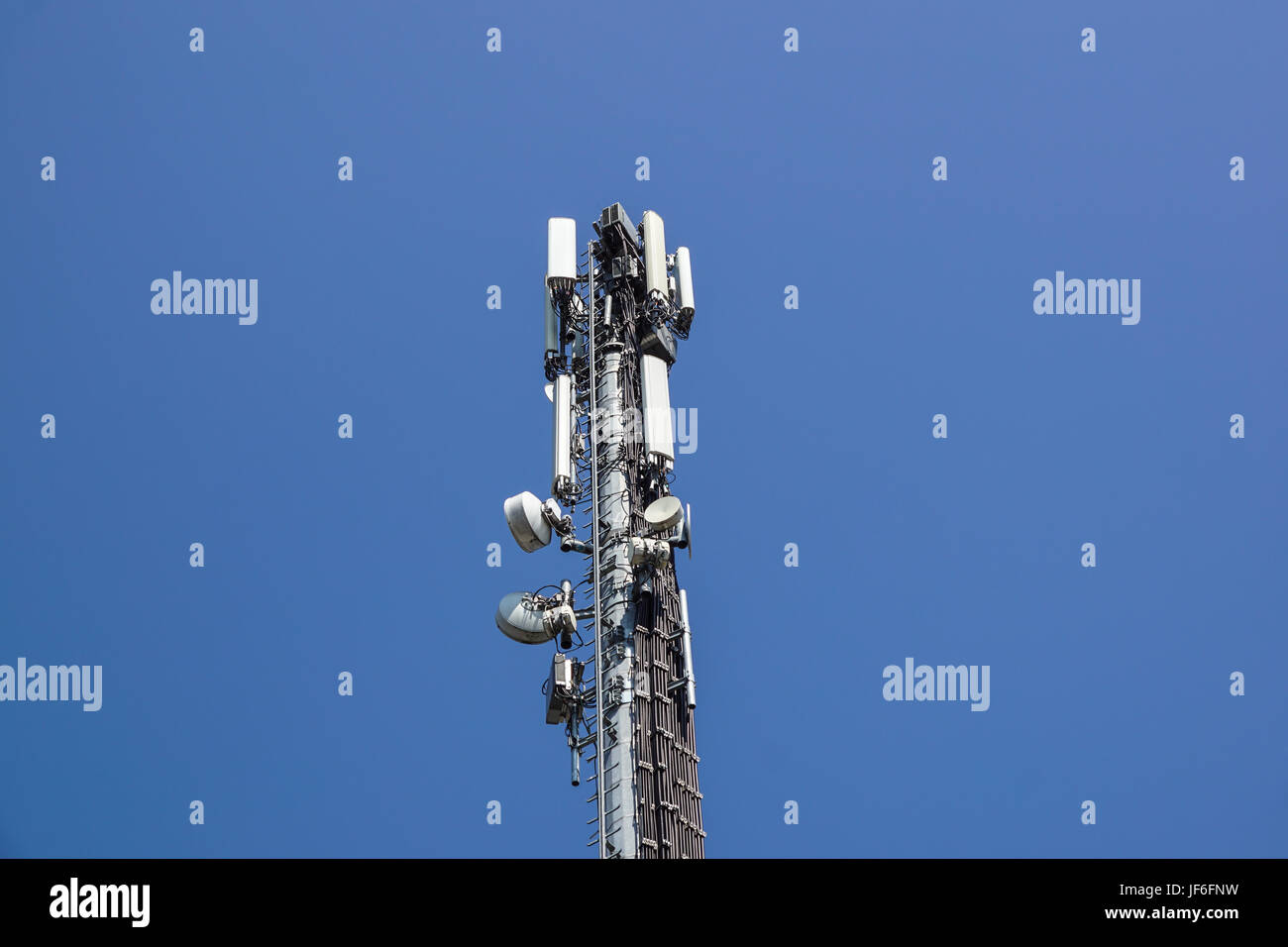 Communication tower antenna with blue sky background . Stock Photo