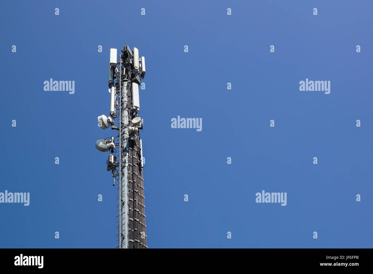 Communication tower antenna with blue sky background . Stock Photo