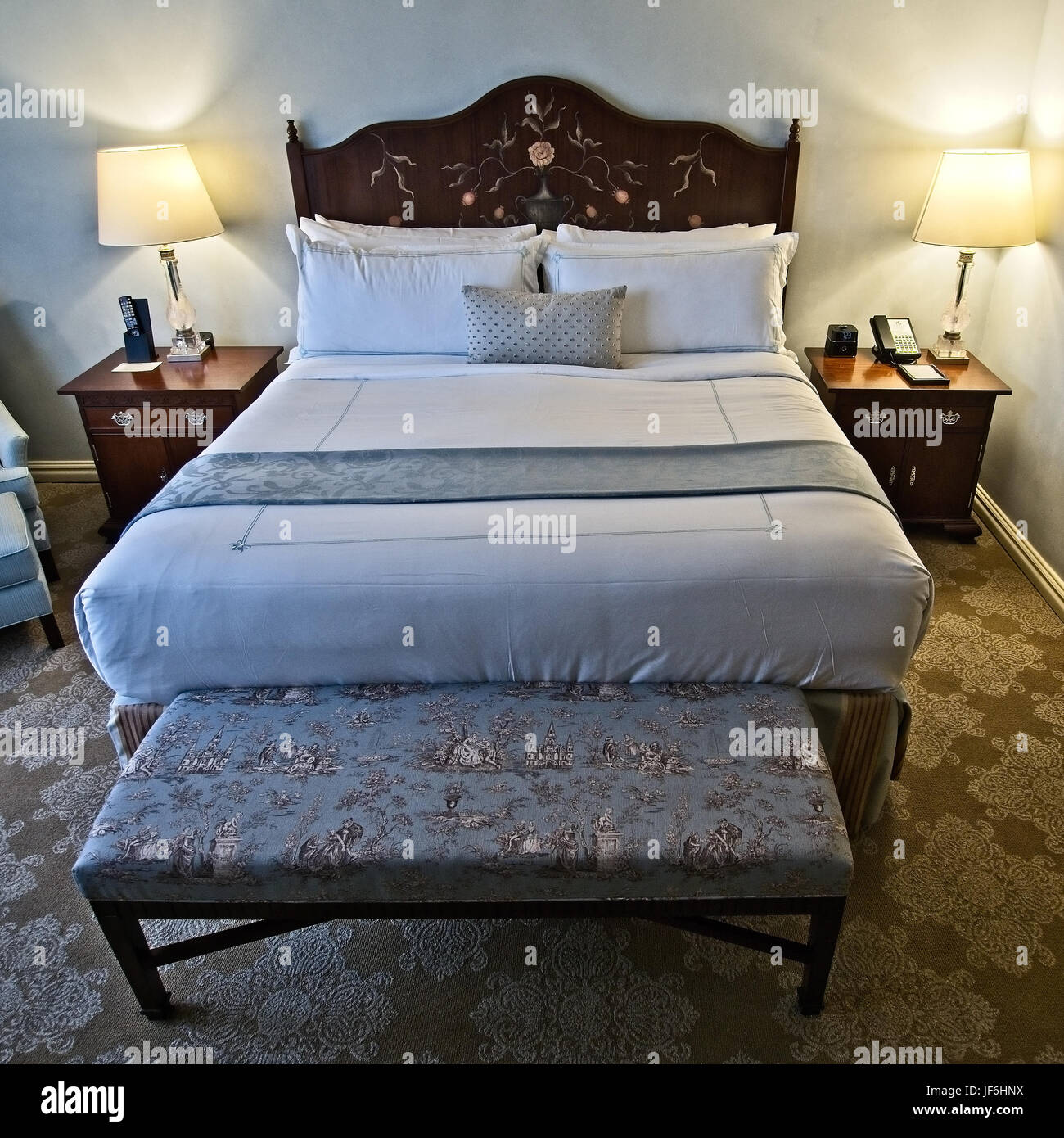 New Orleans, LA USA - May 28, 2017  -  Bed in a hotel in New Orleans with a interesting headboard Stock Photo