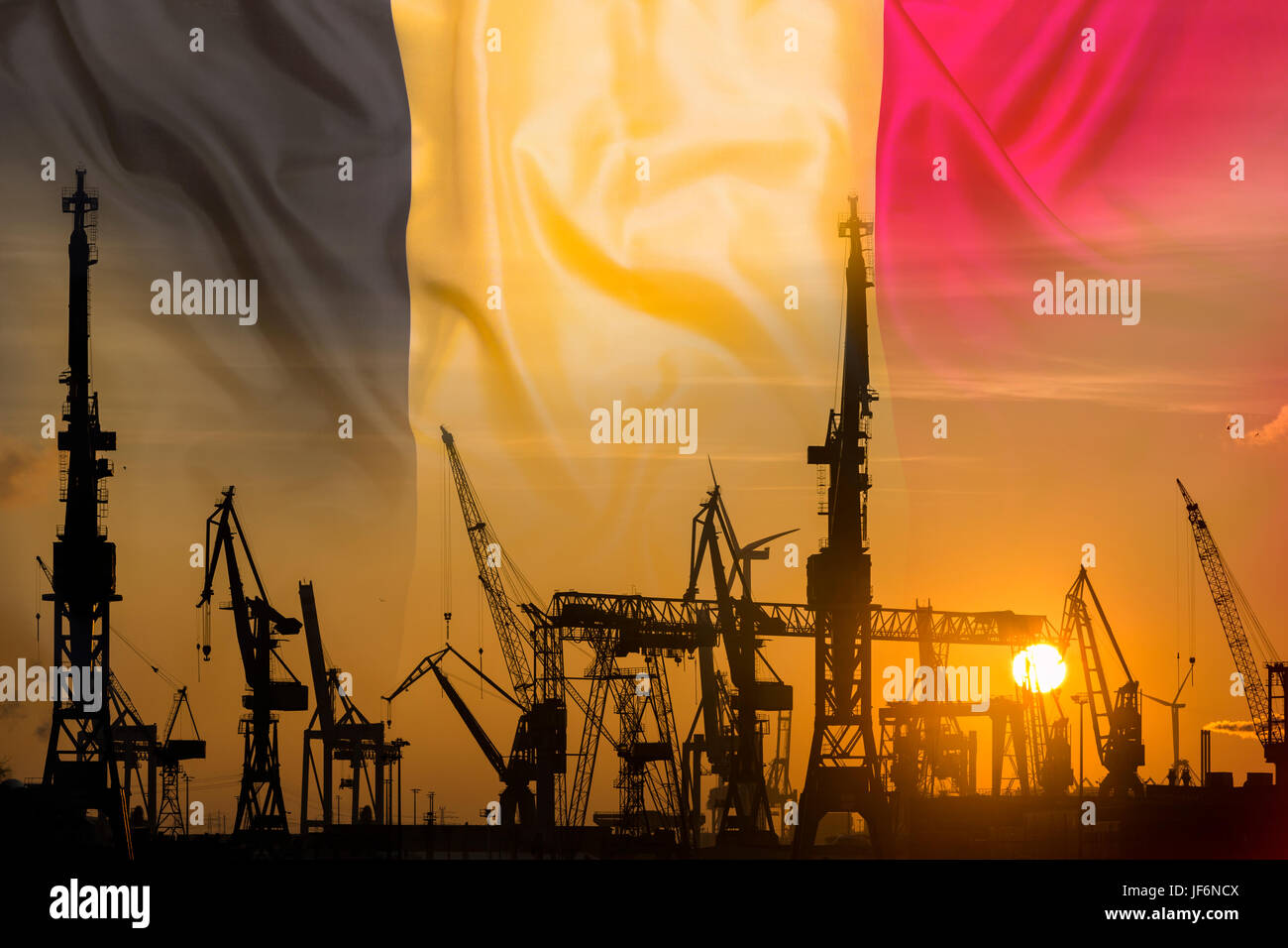 Industrial concept with Belgium flag at sunset, silhouette of container harbor Stock Photo