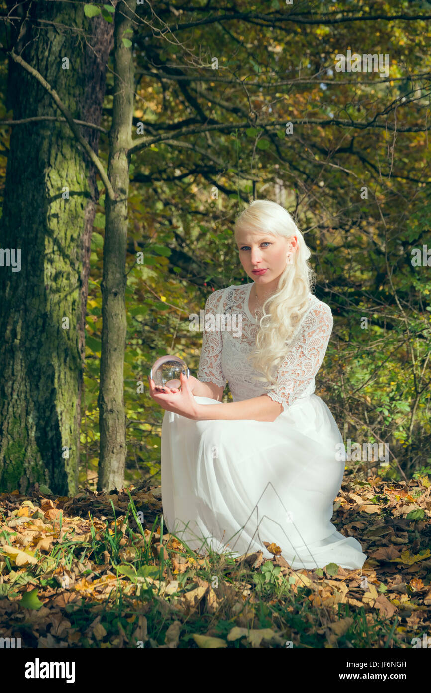 Fortune teller woman sitting in the woods Stock Photo