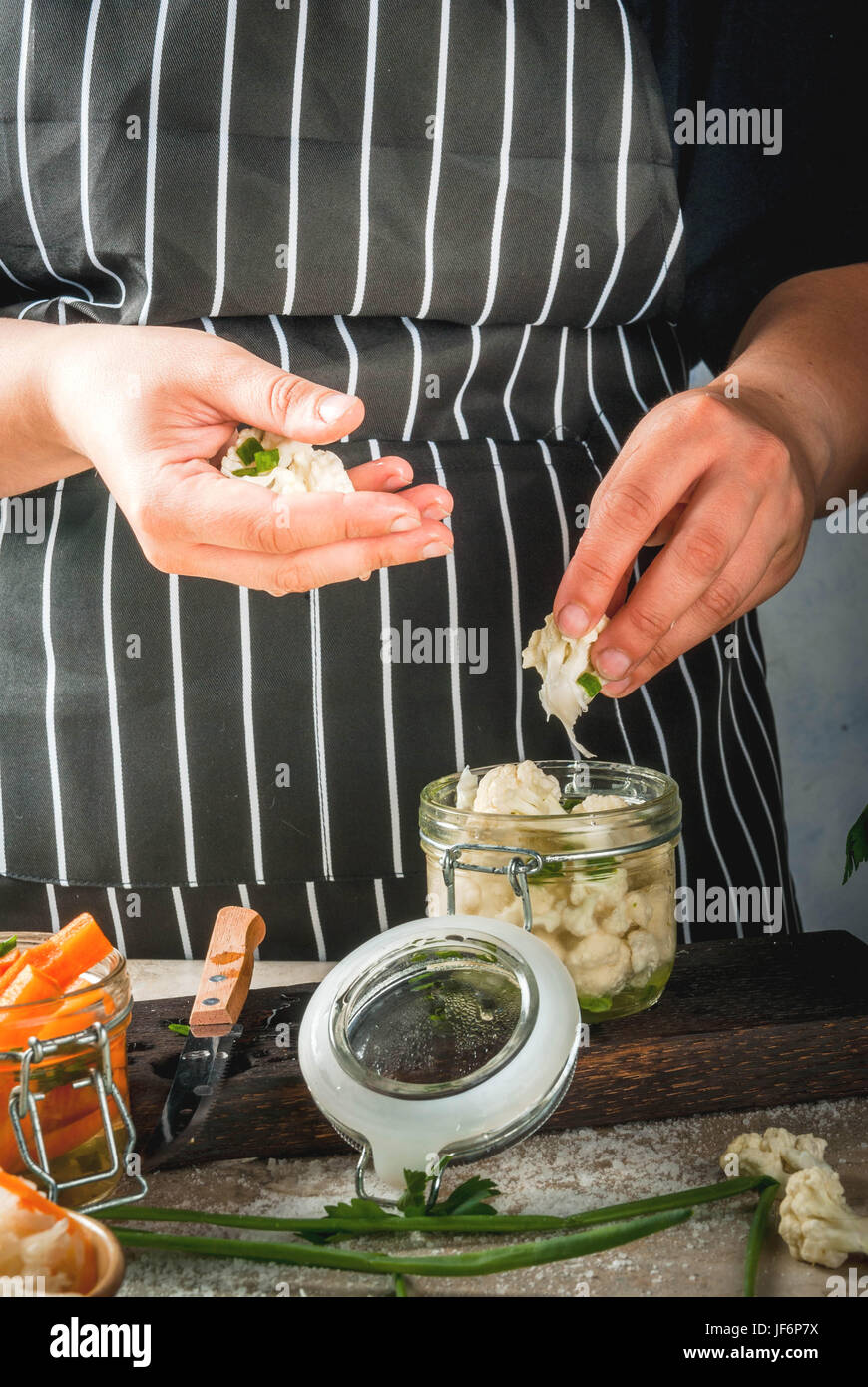 Concept of fermented meal. Canned food. Vegan food. Vegetables. Person (woman) cook fermented