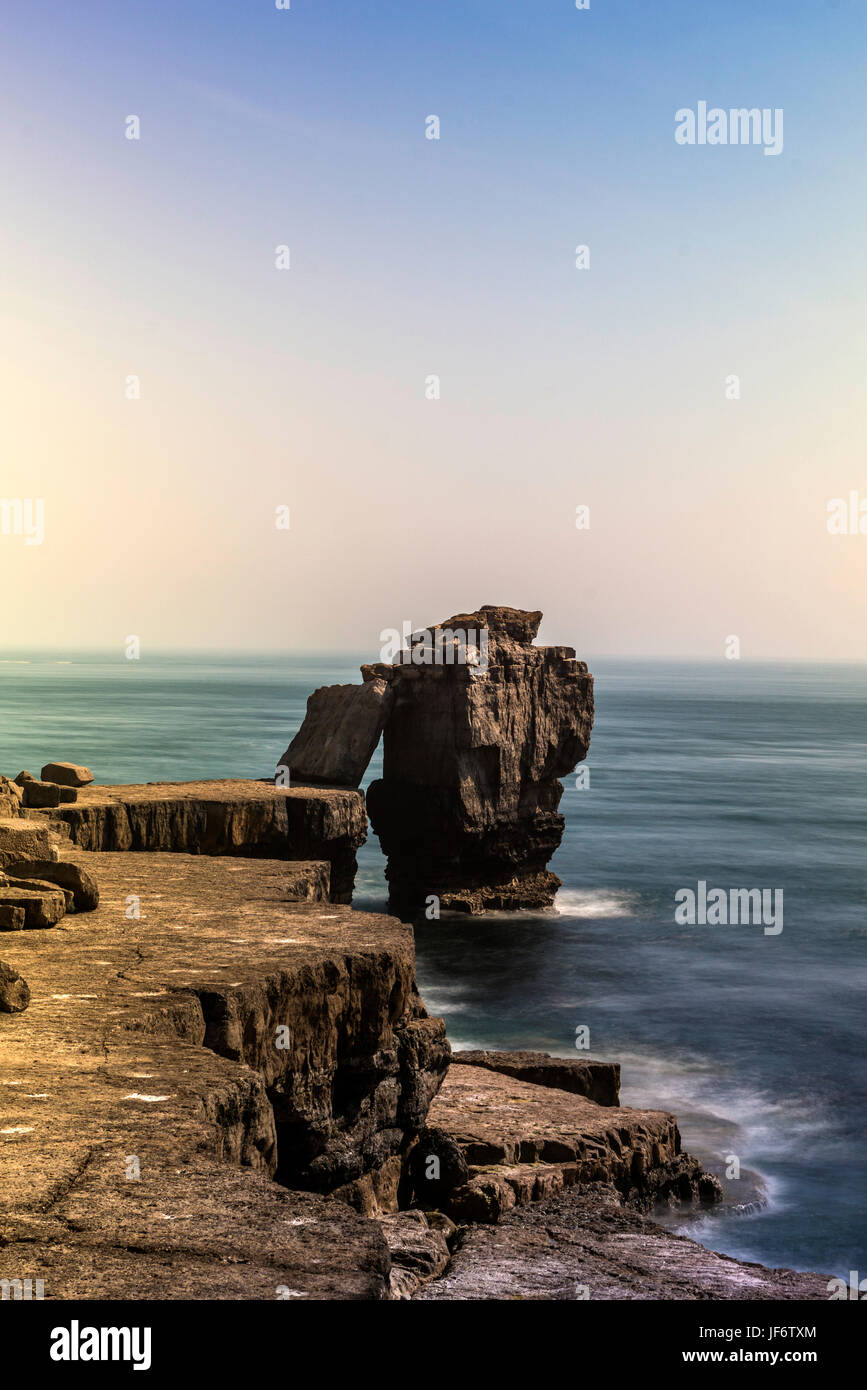 Seascape depicting the Pulpit Rock from the Quarries pathway, with clear blue skies and calm seas on a beautiful summers day. Stock Photo