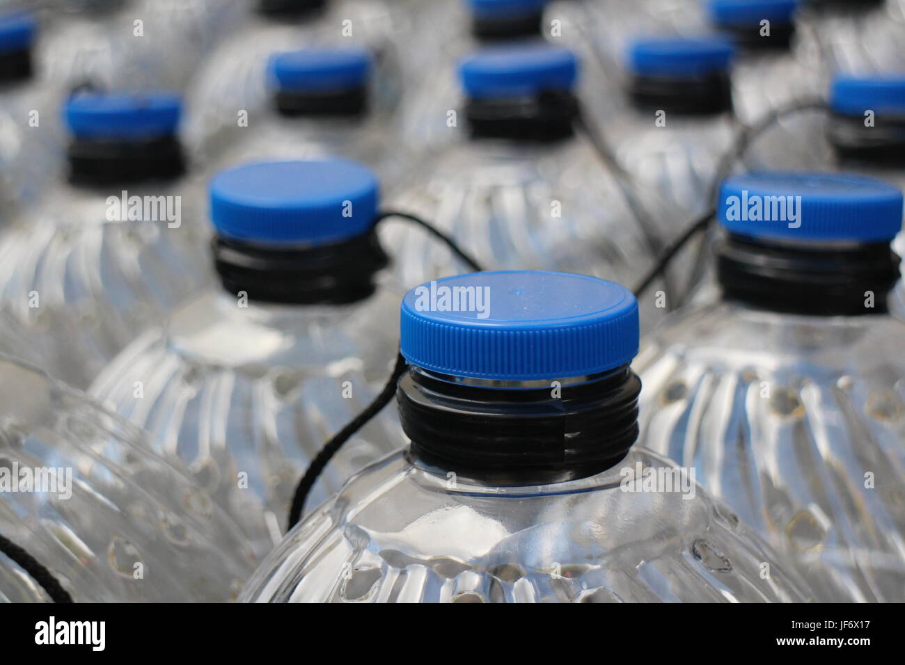 plastic bottles with blue lids Stock Photo Alamy