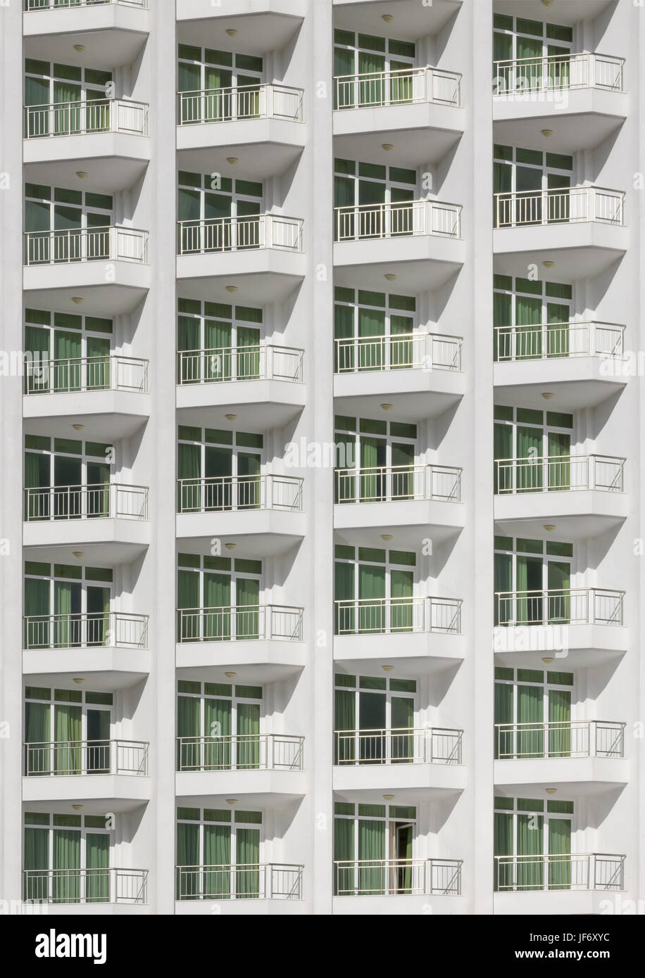 repeating pattern of windows and balcony.Building front white color. Stock Photo