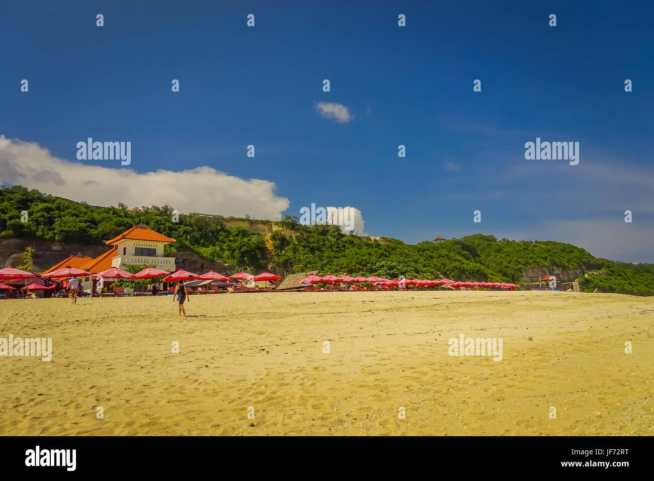 Beautiful sunny day with umbrellas in a row in the beach of Pantai ...