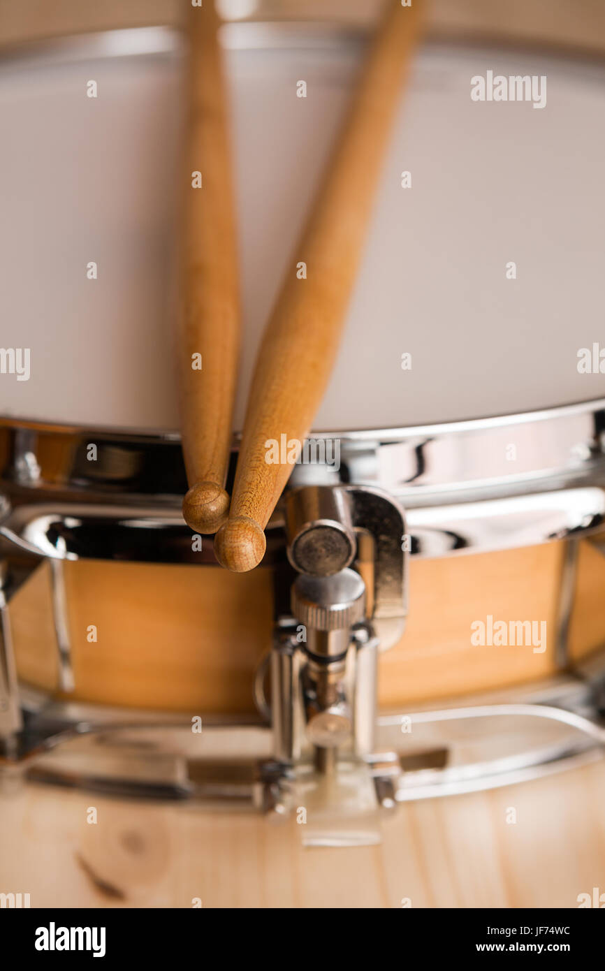 Drum sticks over a snare drum Stock Photo Alamy