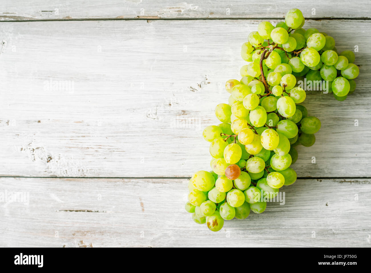 Grapes on the white wooden table top view Stock Photo