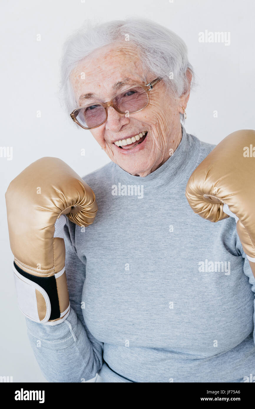 Portrait of senior woman wearing boxing gloves Stock Photo - Alamy