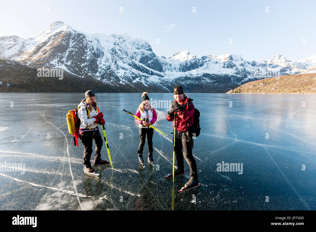 Portrait of ice skaters on frozen lake Stock Photo - Alamy