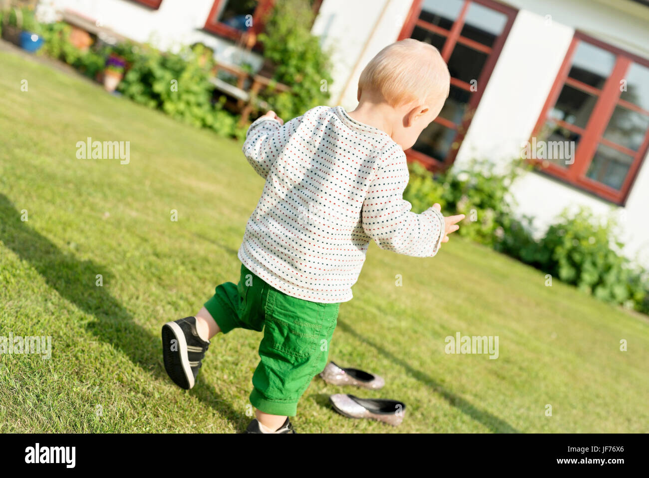 Baby boy walking in garden Stock Photo Alamy