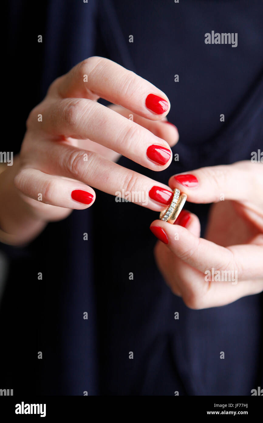 Woman putting on a ring Stock Photo