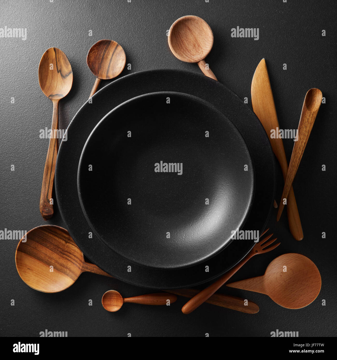 two plates and wooden cutlery Stock Photo Alamy