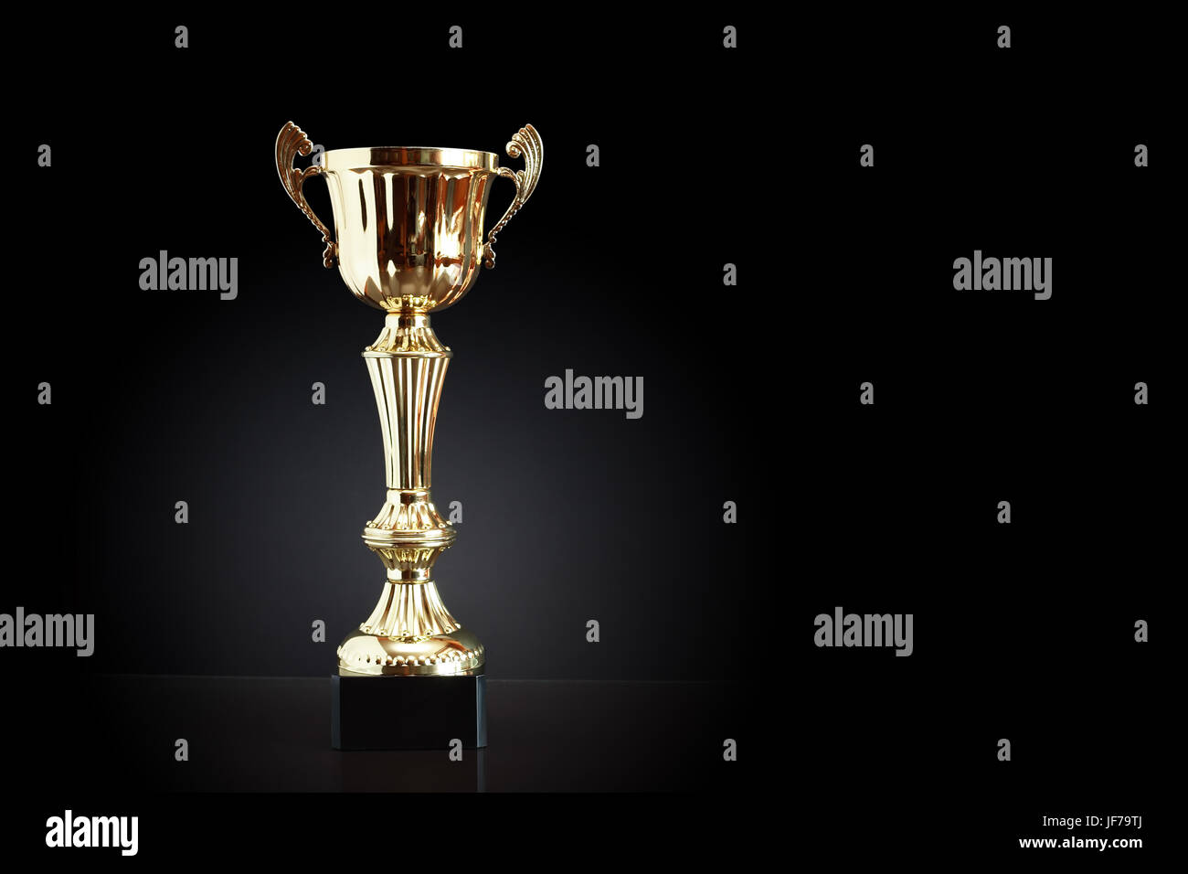 Gold trophy on black background with free space for text Stock Photo