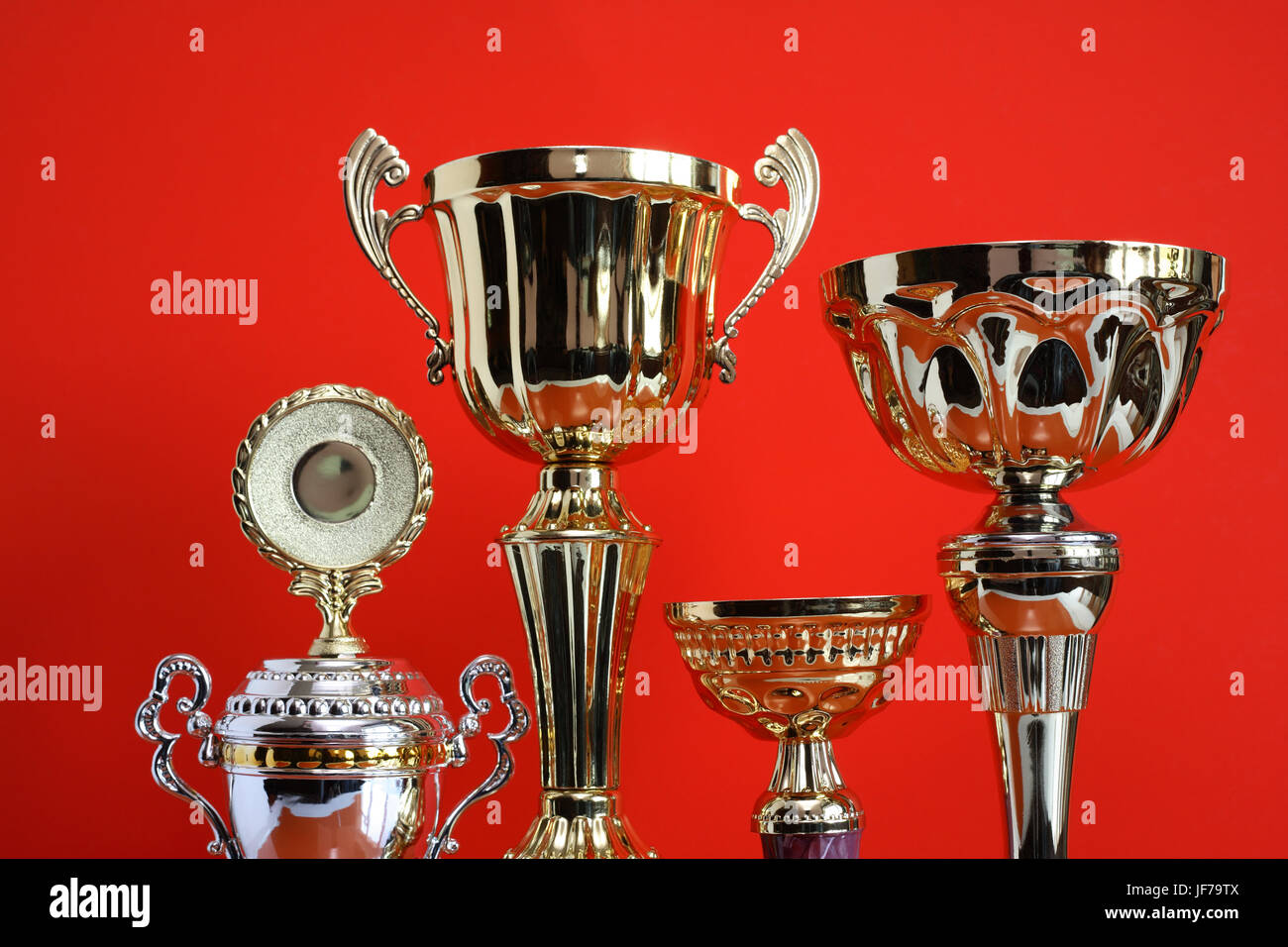 Closeup of gold trophy set on nice red background Stock Photo