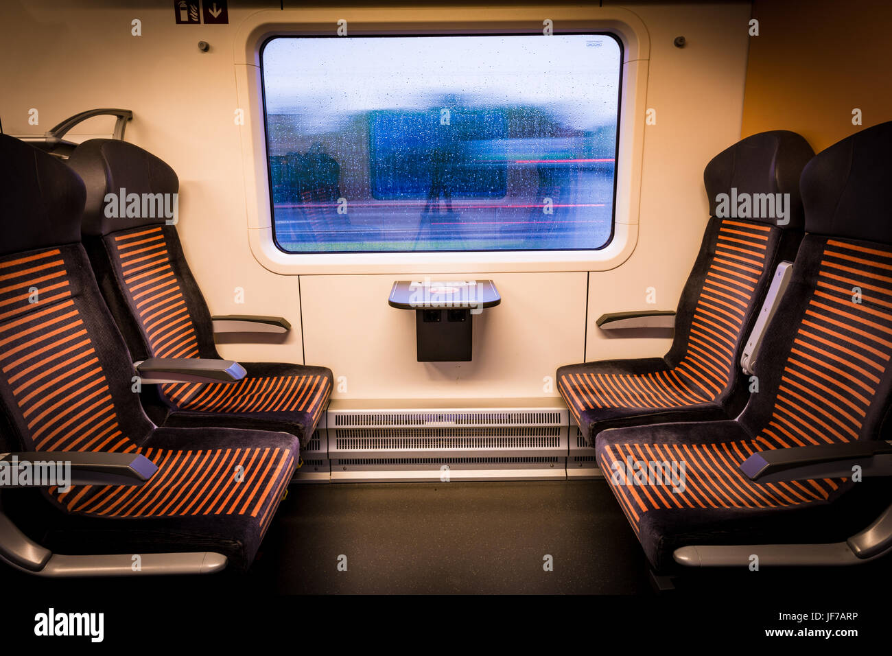 Inside modern train looking out of the window Stock Photo