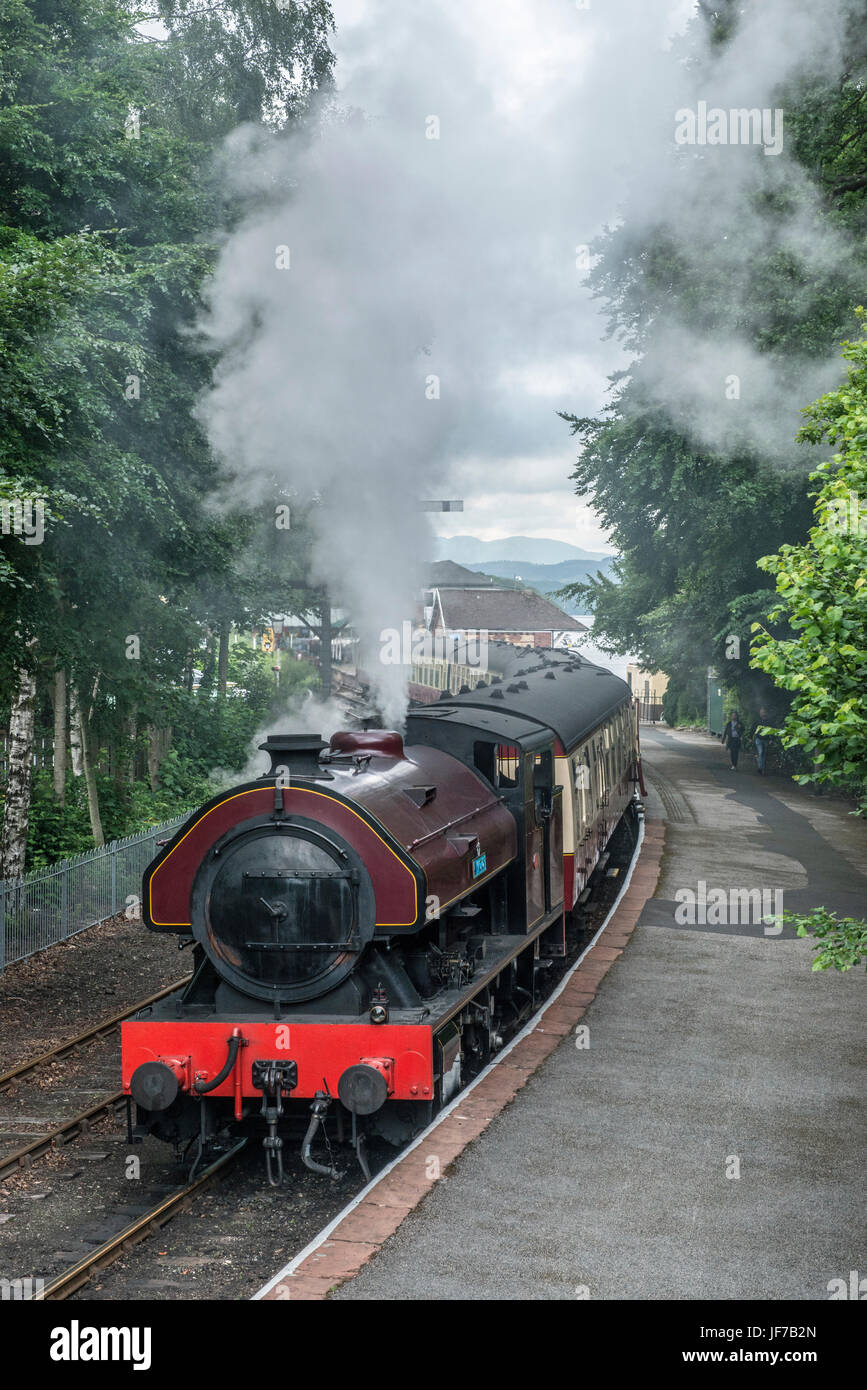 Steam locomotive leaving Lakeside Railway Station Lake District Stock Photo