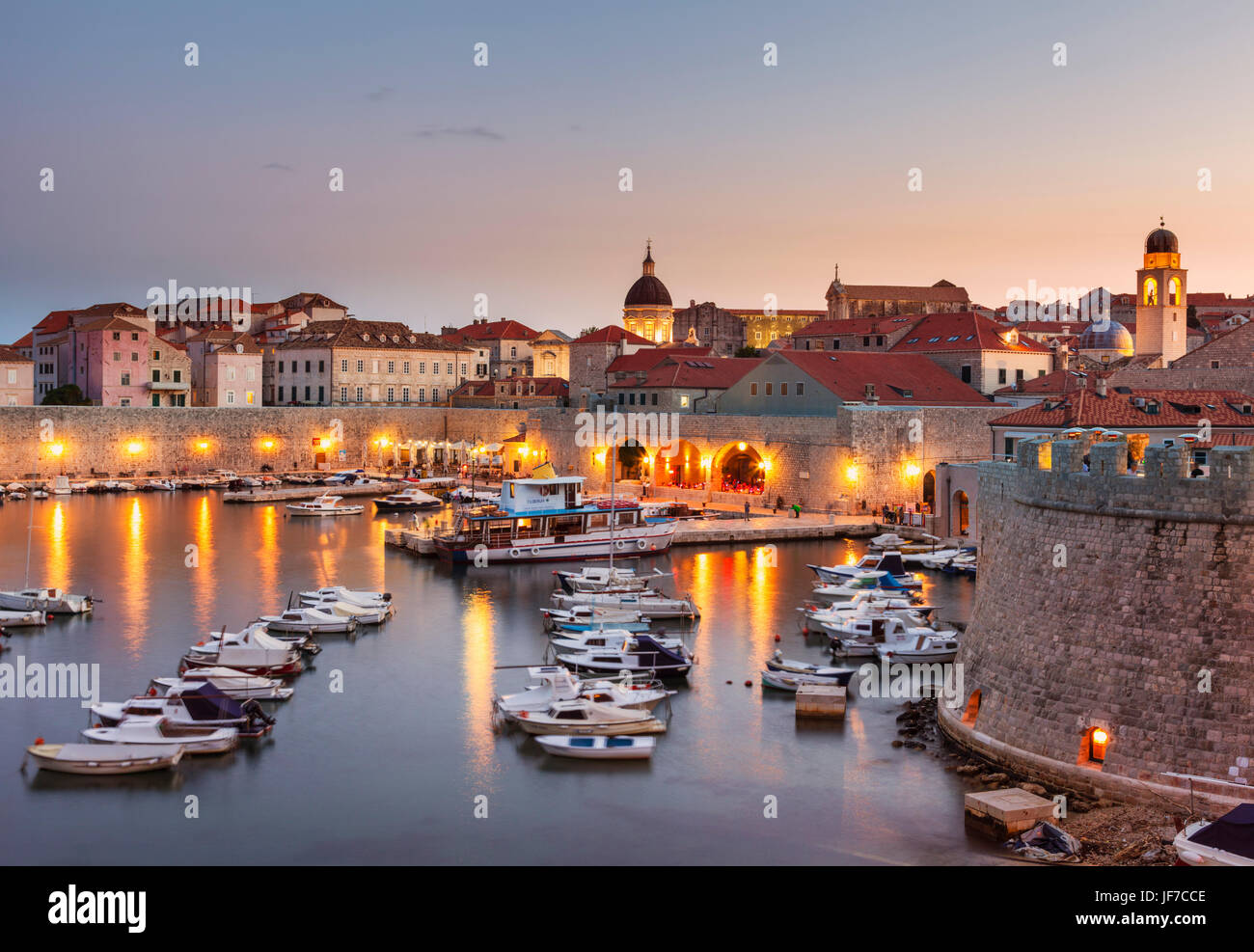 Croatia Dubrovnik Croatia Dalmatian coast view of Dubrovnik old Town illuminated city walls old port and harbour sunset night Dubrovnik Croatia Europe Stock Photo