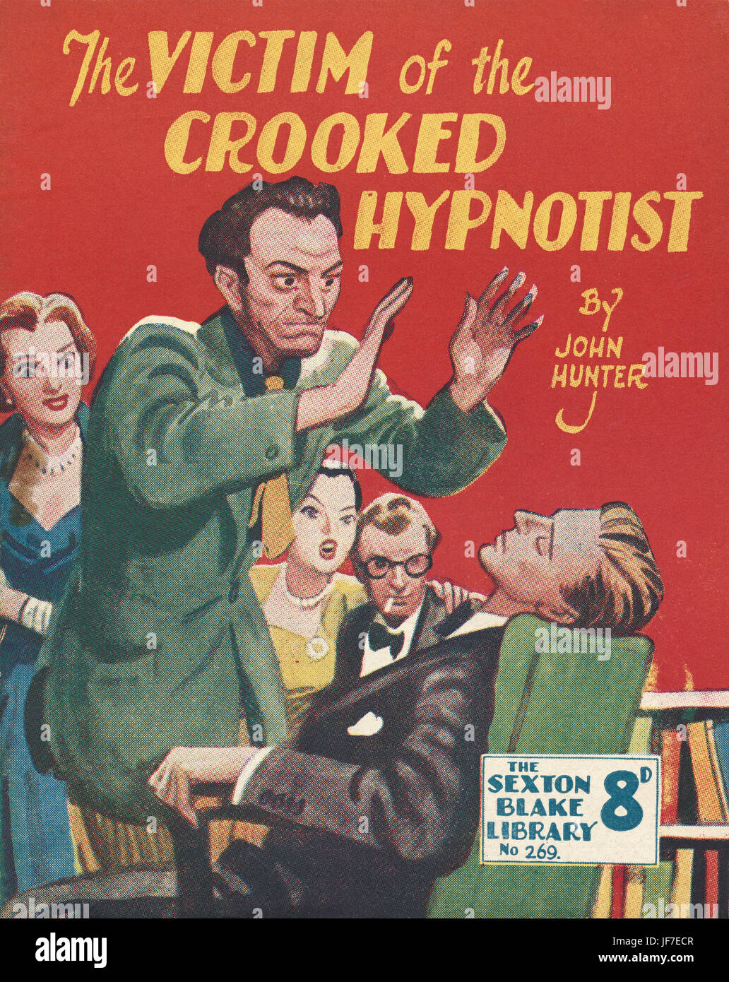 'The Victim of the Crooked Hypnotist,' by John Hunter - book  cover illustration. One man is hypnotised while party guests look on, enthralled.  Artist: Camps.  From The Sexton Blake Library, March 1952.  Published by Fleetway Publications, London. Stock Photo