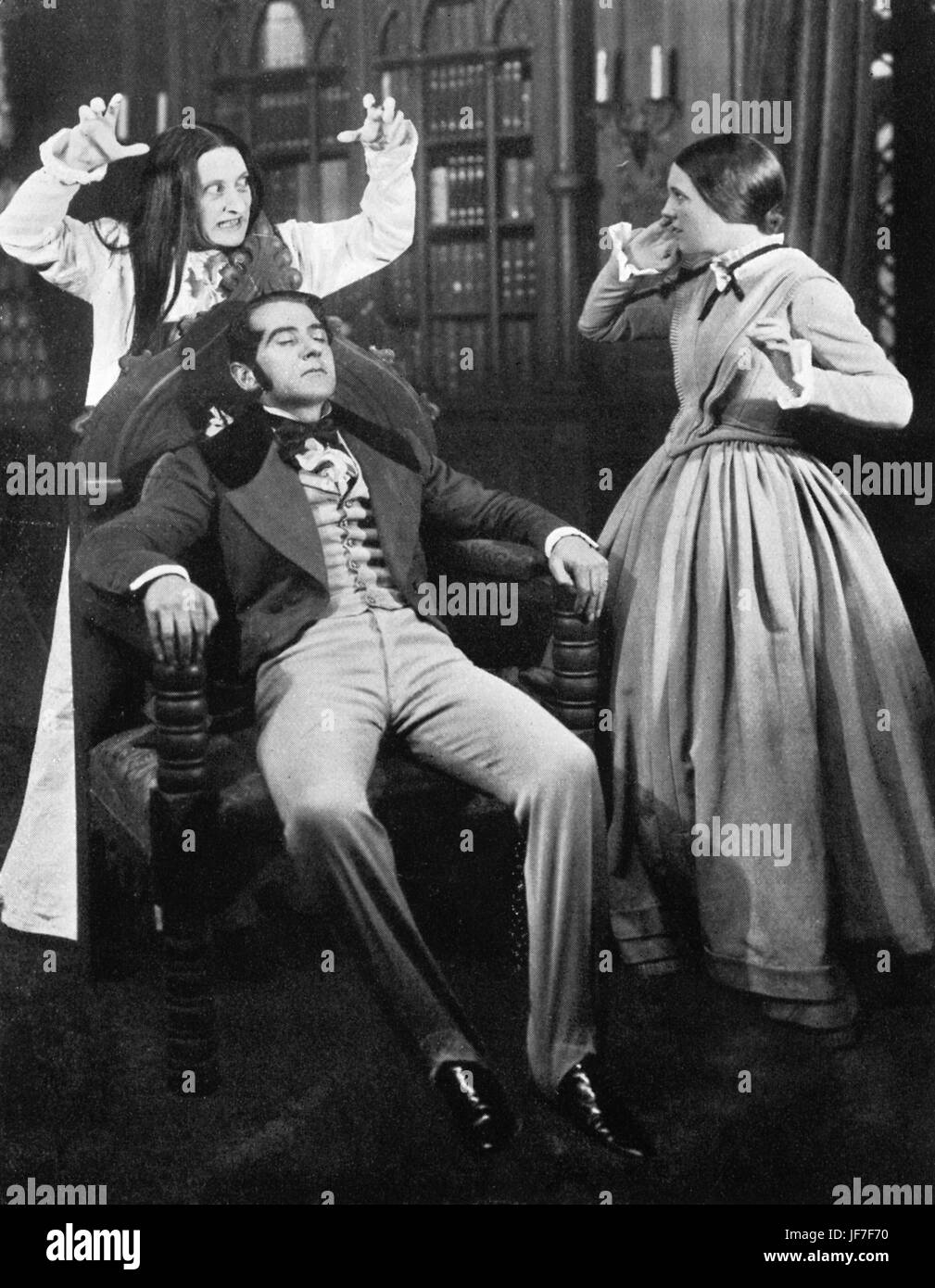 'Jane Eyre' with Reginald Tate as Mr Rochester, Curigwen Lewis as Jane and Dorothy Hamilton as Mrs Rochester.  Jane enters the library in time to save Mr Rochester. Cyril Phillips 's production,  the Queen's Theatre, London, 1936. Based on the novel by Chalotte Bronte. RT, English actor, 13 December 1896 – 23 August 1955. Stock Photo