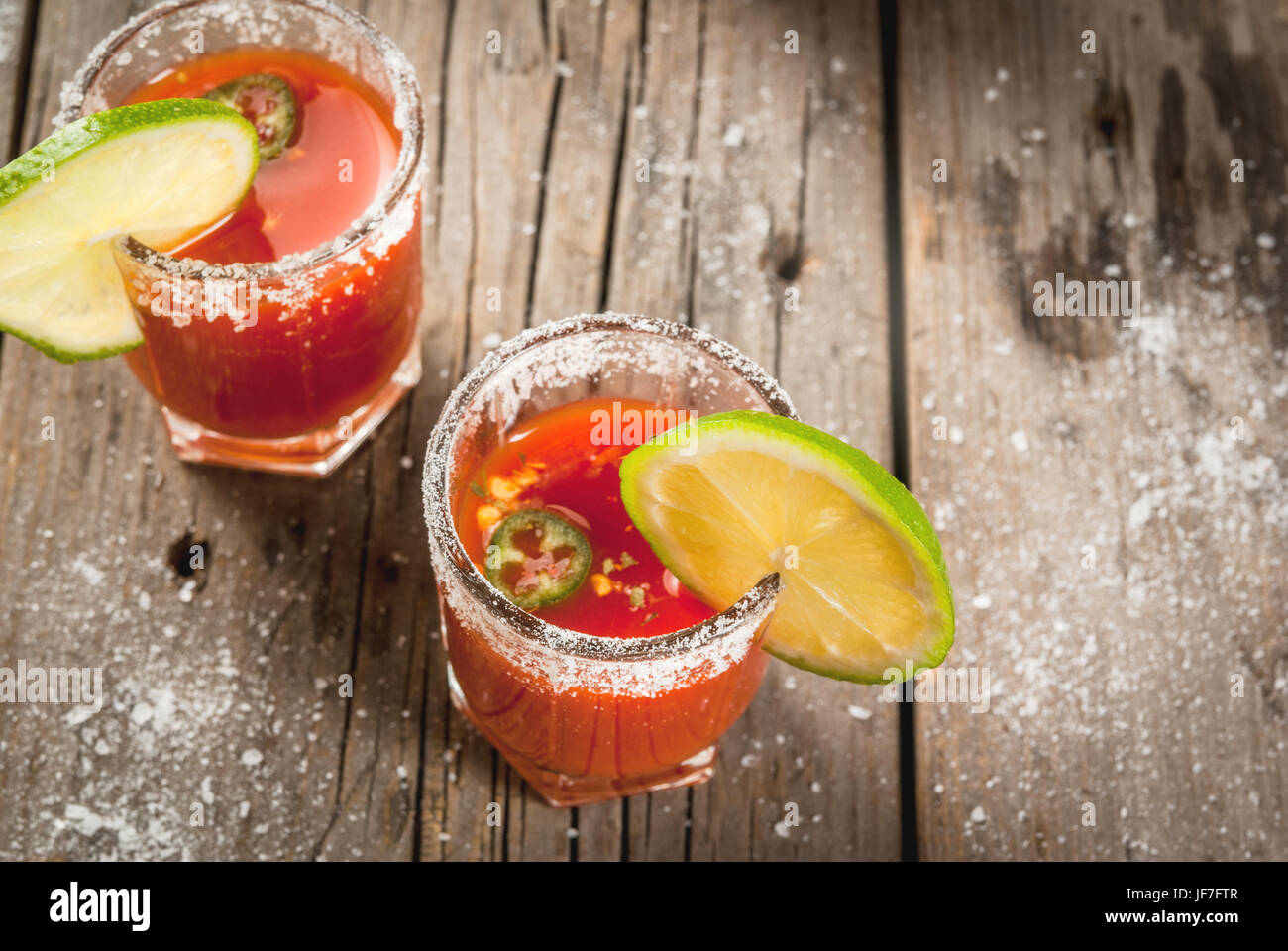 Mexican traditional alcohol drink. Sangrita, with tequila, tomato juice, hot spices, chili and