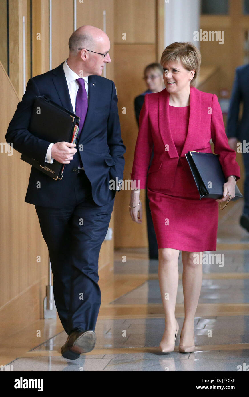 First Minister Nicola Sturgeon and Deputy First Minister John Swinney arrive ahead of First Minister's Questions at the Scottish Parliament in Edinburgh. Stock Photo