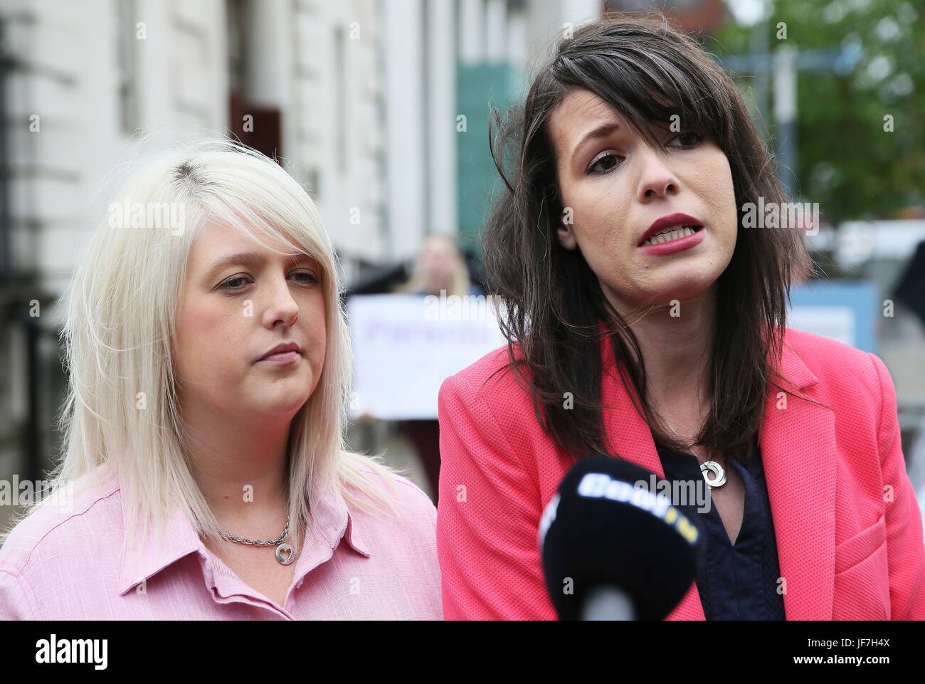Pro-choice campaigner Sarah Ewart (left), who had to travel to England for an abortion due to fatal foetal abnormality, and Grainne Teggart of Amnesty International, speak to media outside the Royal Courts of Justice, Belfast, where the Court of Appeal allowed an appeal against a lower court's ruling that abortion legislation was incompatible with the UK's Human Rights Act. Stock Photo