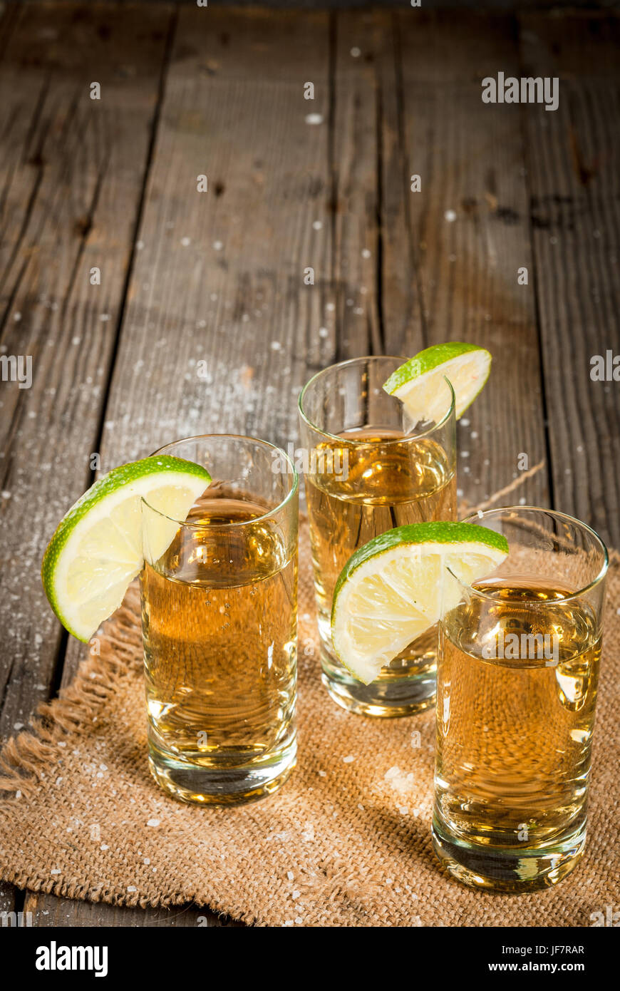 Traditional Mexican alcoholic beverage is a golden tequila. In tall ...