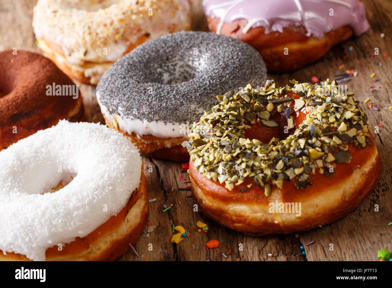 Homemade glazed multicolored donuts close-up on the table. horizontal Stock Photo