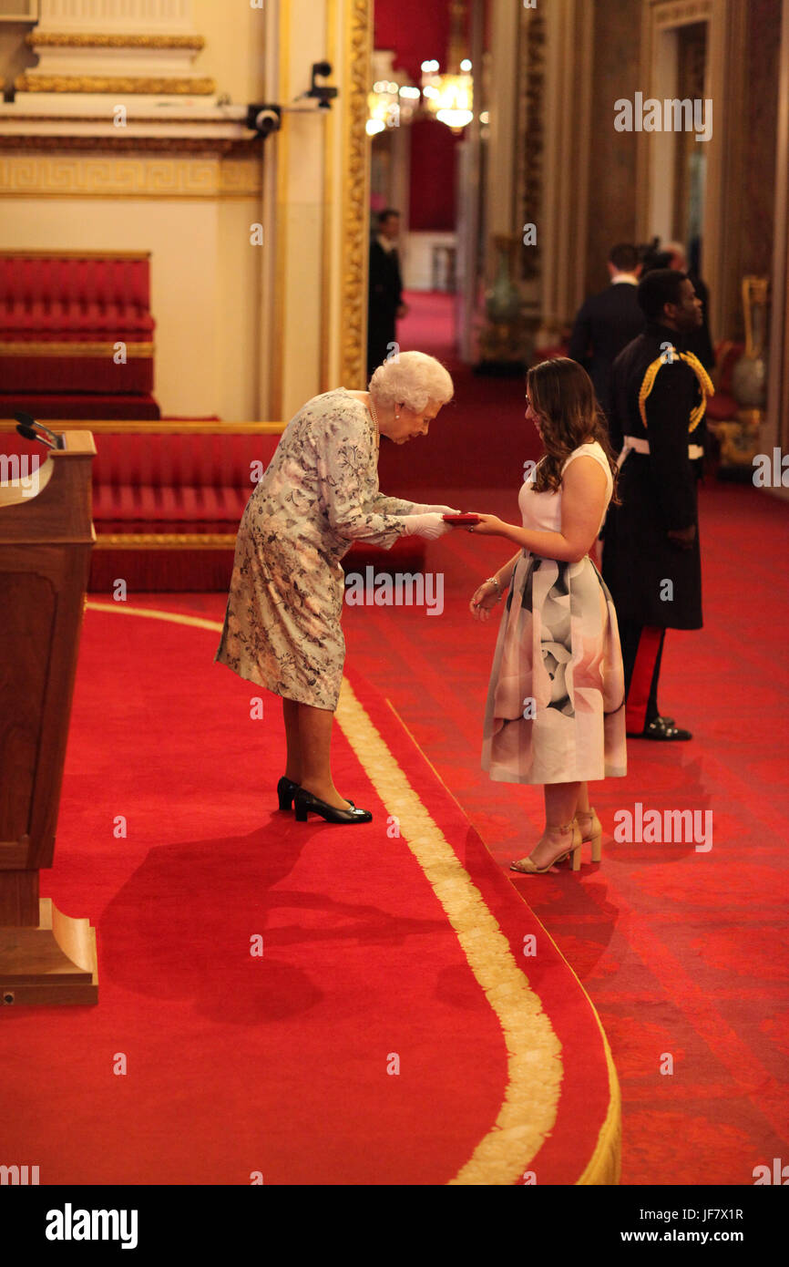 Miss Madeleine Buchner from Australia receives a Queen's Young Leaders Award for 2017 from Queen Elizabeth II during a ceremony at Buckingham Palace in London. Stock Photo
