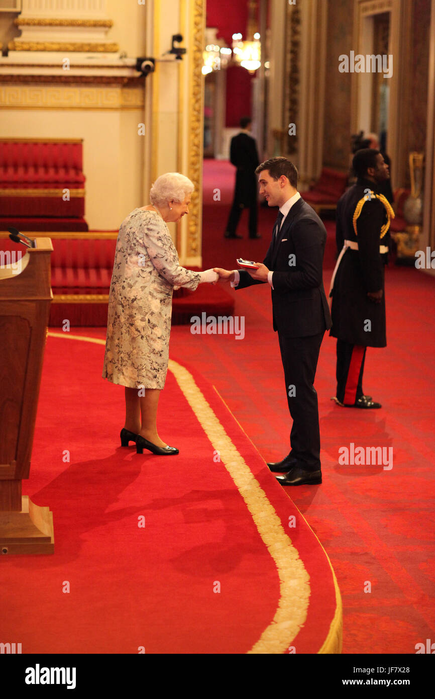 Jordan O'Reilly from Australia receives a Queen's Young Leaders Award for 2017 from Queen Elizabeth II during a ceremony at Buckingham Palace in London. Stock Photo