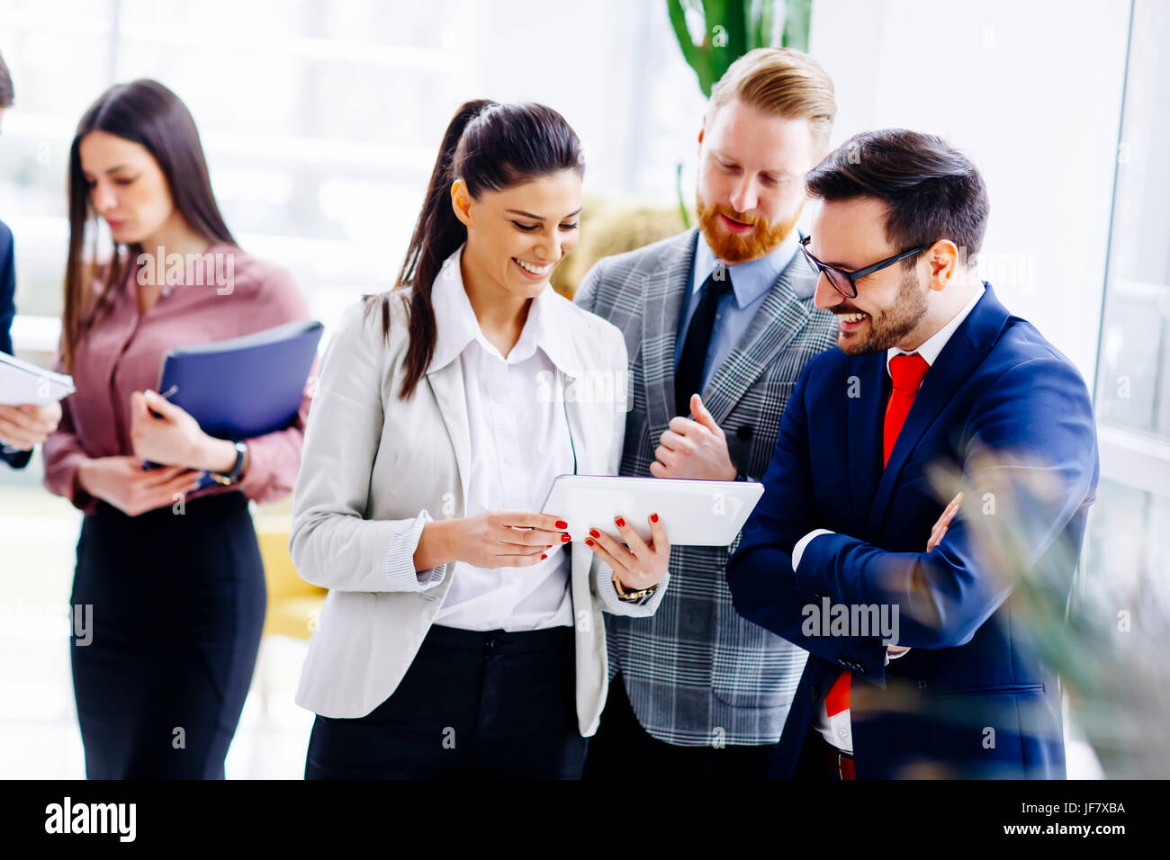 Group of businesspeople standing in the modern office Stock Photo - Alamy