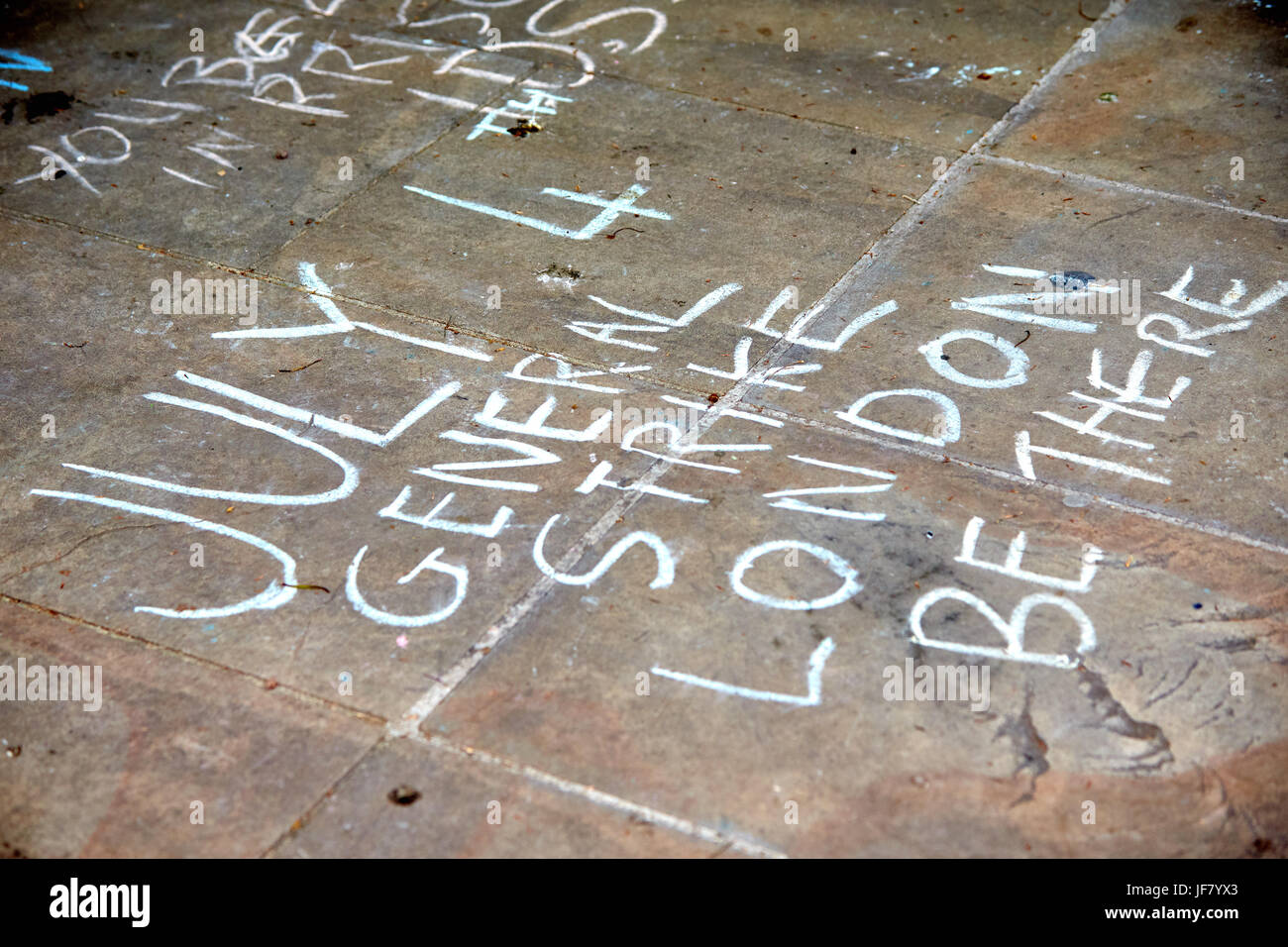 A chalk message on paving stones about a general strike on 4th July Stock Photo