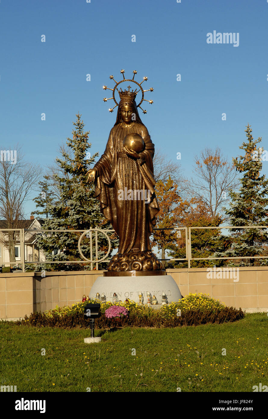 A tall bronze statue of Mother Mary. Stock Photo