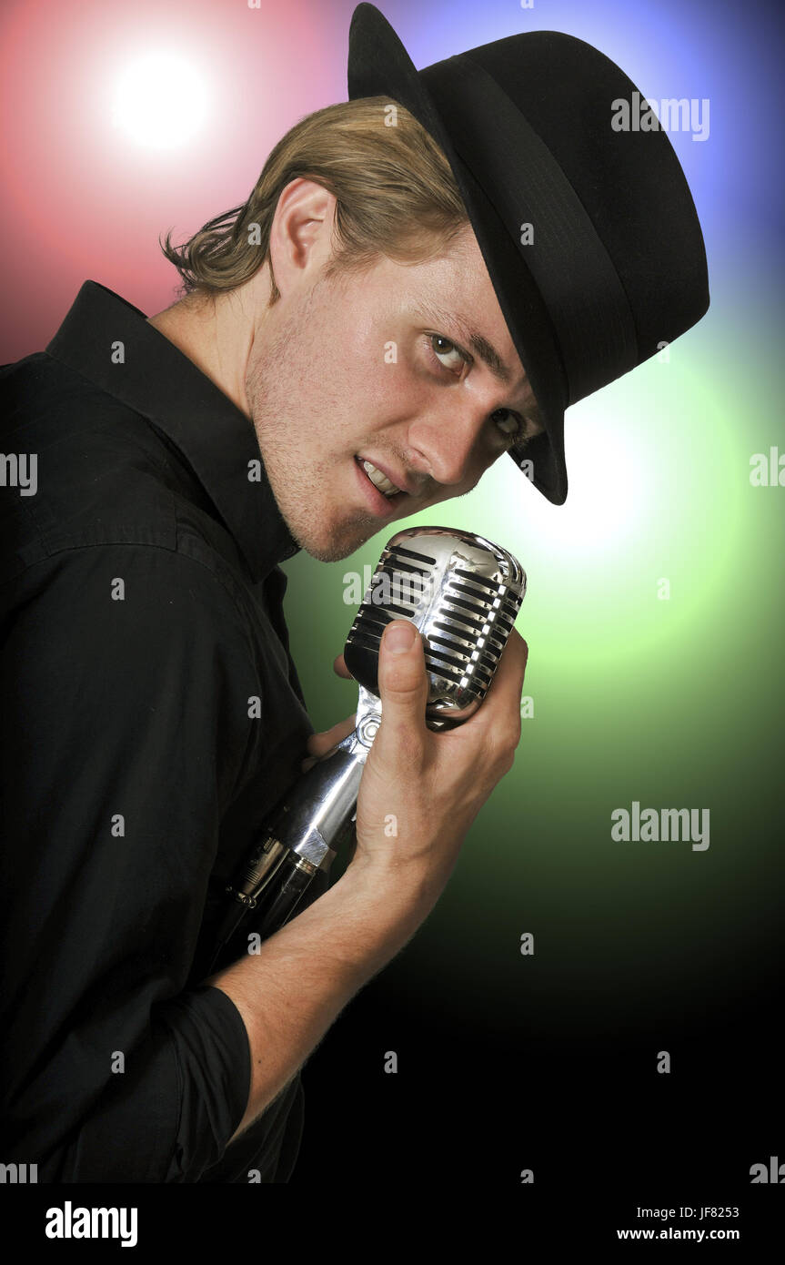 Man singing into microphone Stock Photo