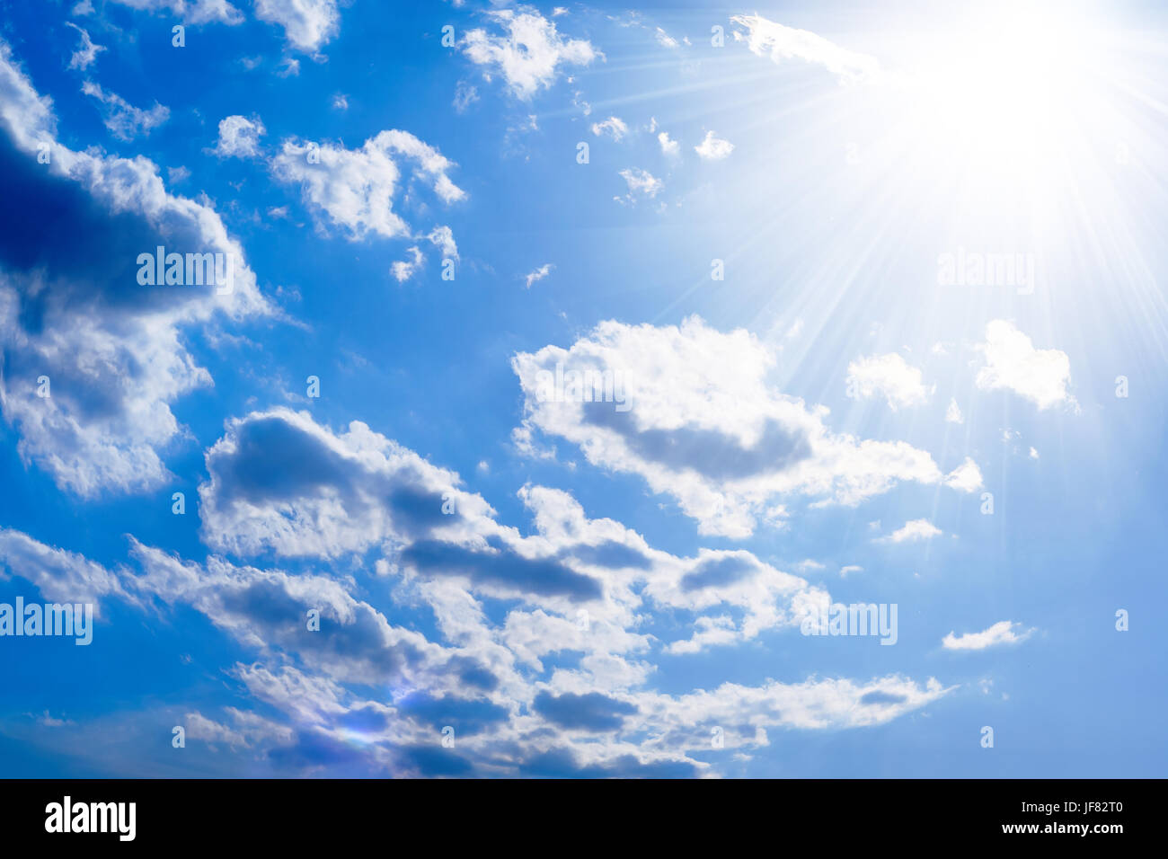 The sun and scattered clouds Stock Photo - Alamy