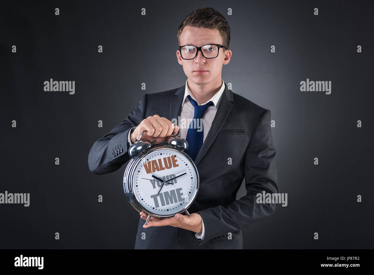Young businessman time importance concept Stock Photo - Alamy