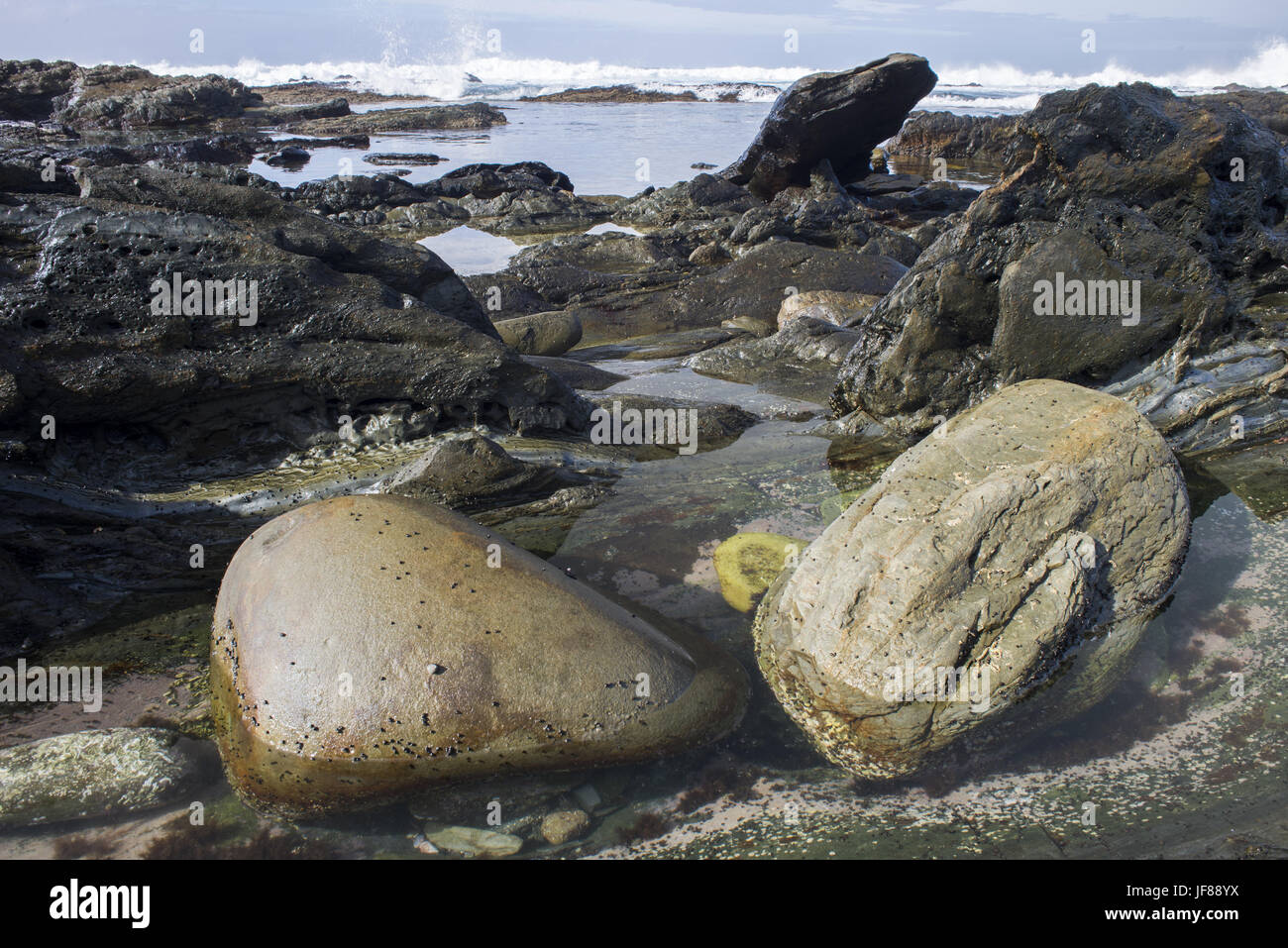 Two Boulders in shallow water Stock Photo