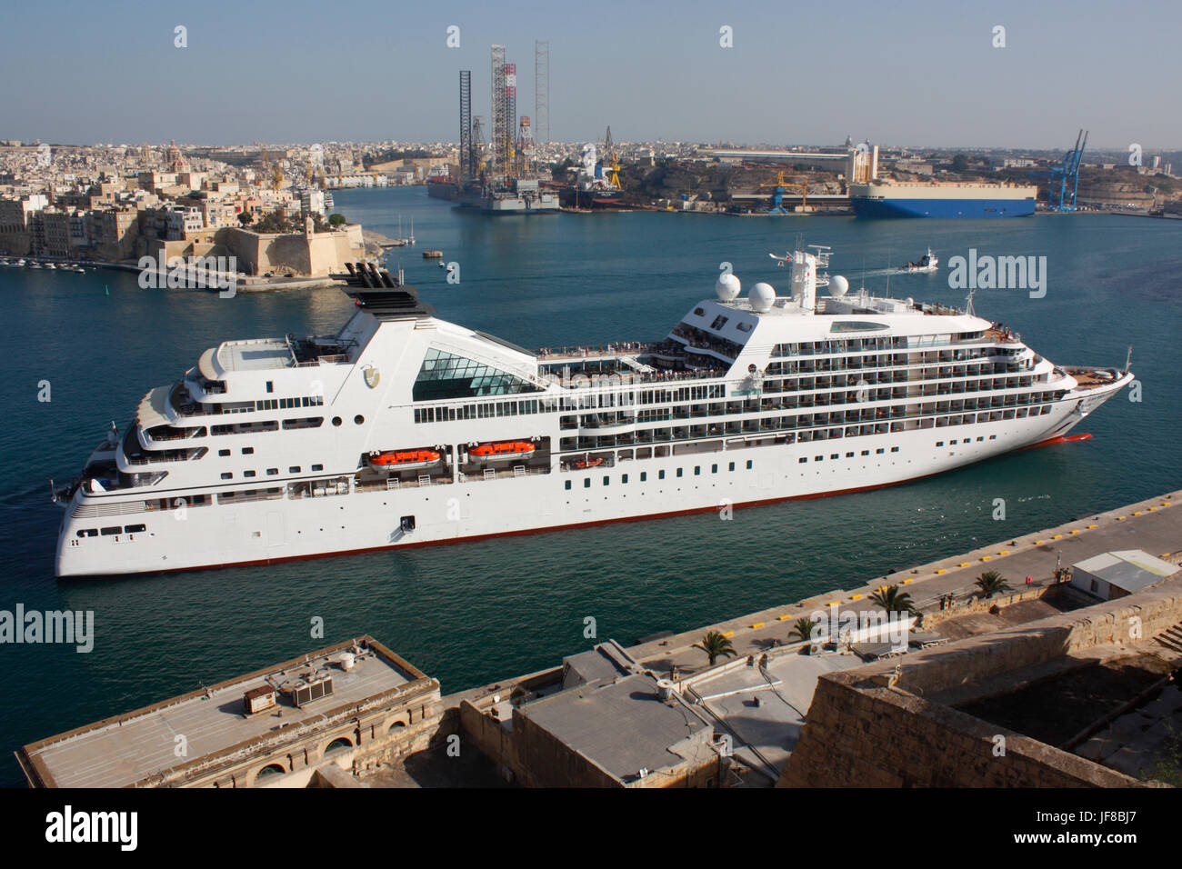 Mediterranean travel and tourism. The cruise ship Seabourn Odyssey on arrival in the Grand Harbour of Malta. Geography and economic development. Stock Photo