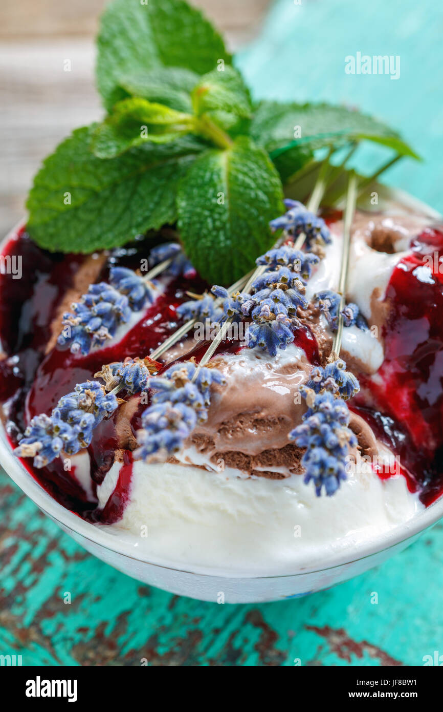 Ice cream with berry topping and lavender. Stock Photo