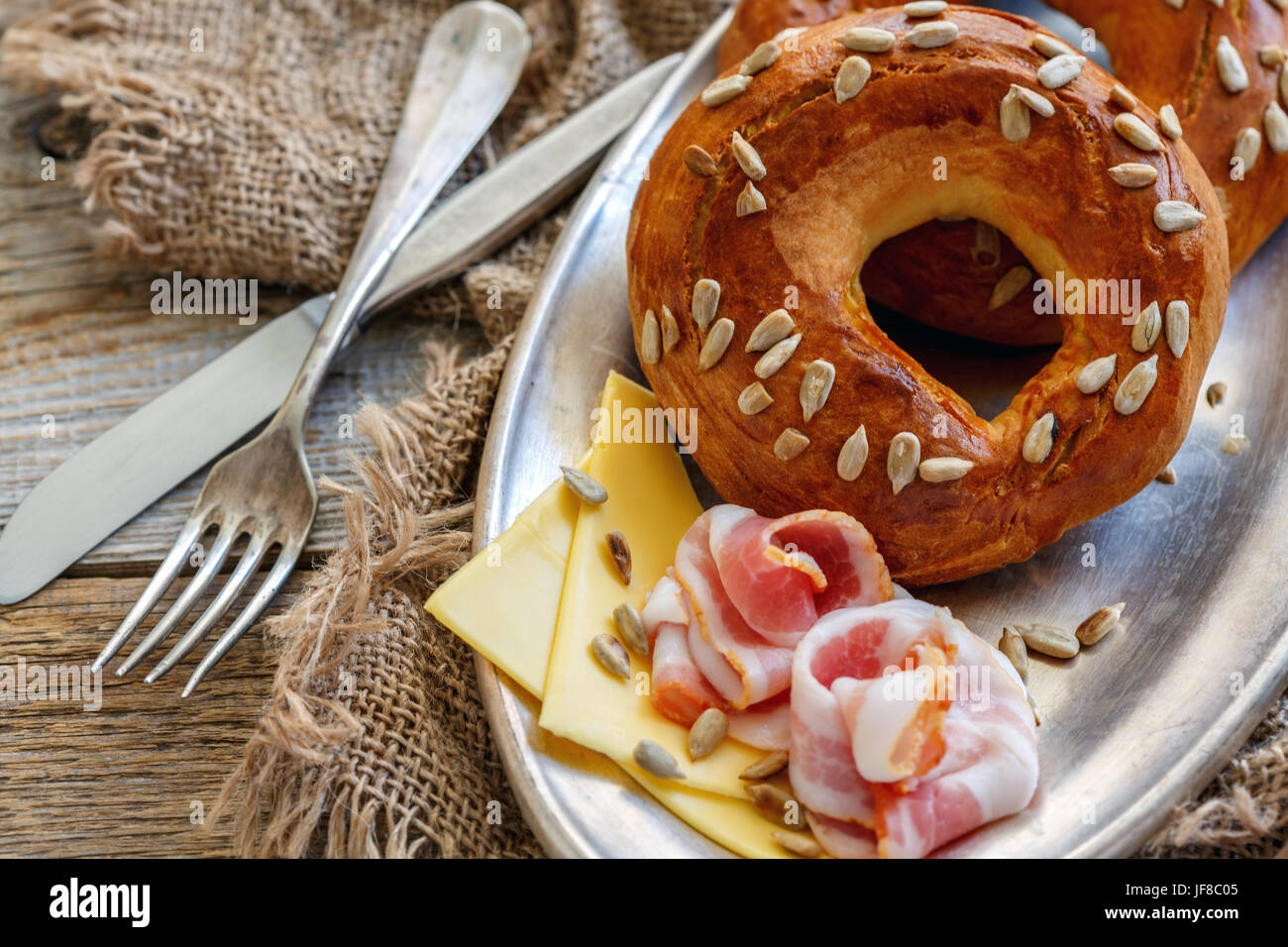 Cheese with bacon and tasty bagel. Stock Photo