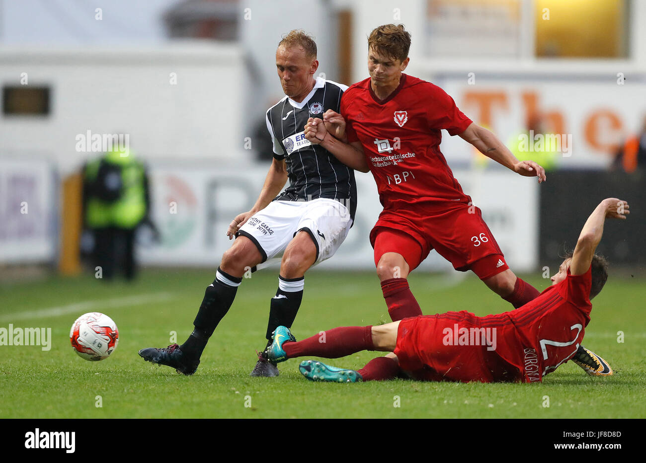 Bala Town FC's Kieran Smith battles for the ball with FC Vaduz's Robin Kamber, during the UEFA Europa League Qualifying first round, first leg match at Belle Vue, Rhyl. Stock Photo
