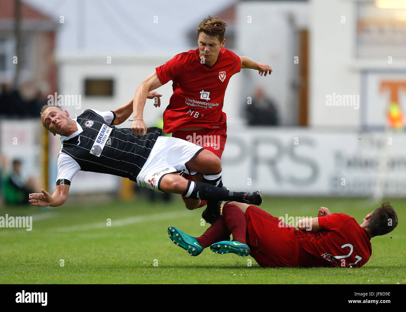 Bala Town FC's Kieran Smith battles for the ball with FC Vaduz's Robin Kamber, during the UEFA Europa League Qualifying first round, first leg match at Belle Vue, Rhyl. Stock Photo