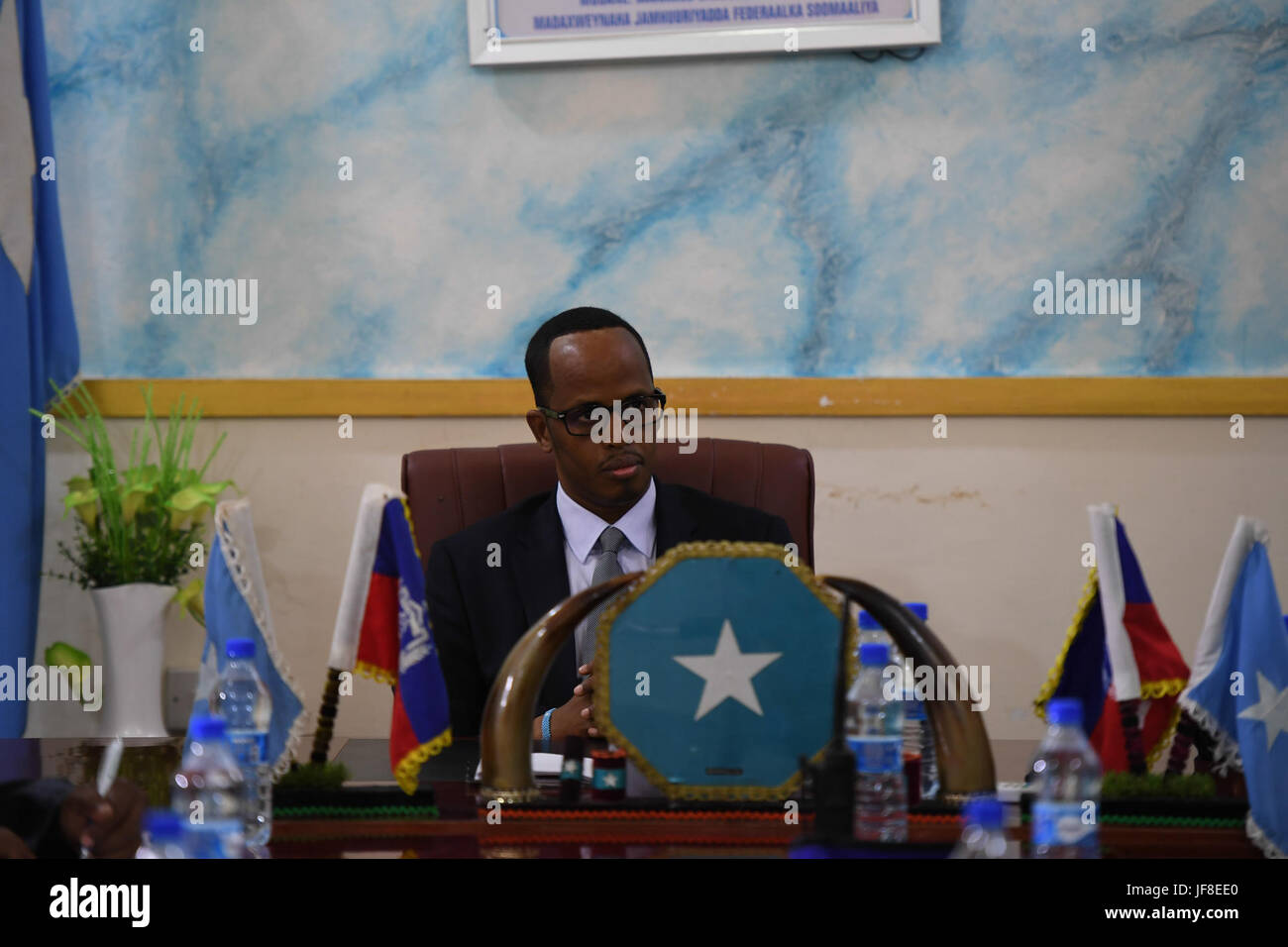 Thabit Abdi Mohamed, the Mayor of Mogadishu who is also the Governor of the Benadir Regional Administration listens during a meeting with senior officers of the African Union Mission in Somalia (AMISOM) at his office in Mogadishu, Somalia on May 13, 2017. AMISOM Photo / Omar Abdisalan Stock Photo